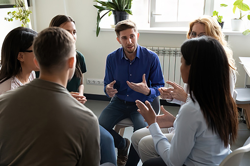 Diverse workgroup solve current issues, discuss common project, taking part in team building talk. Psychologist counselor therapist speak at group therapy session, psychotherapy meeting rehab concept