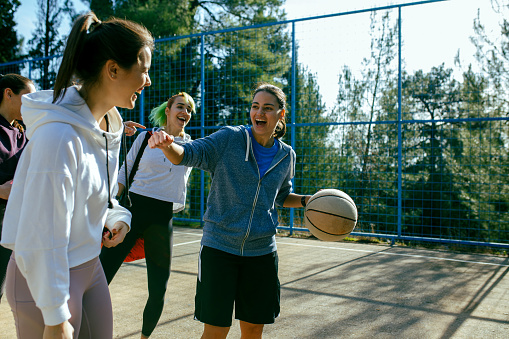 Group on young women on  the court ready to play basketball.